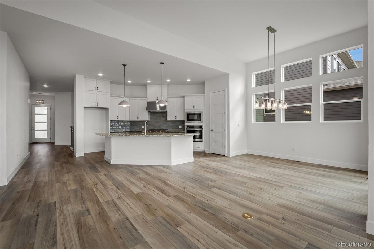 Empty room, Interior, Kitchen, Pendant Lights, Recessed Lighting, Stainless Steel Appliances, Wood Texture Flooring