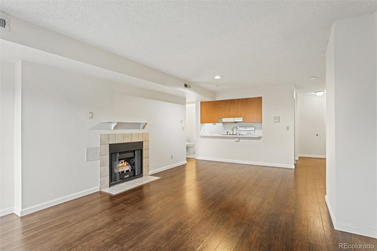 Empty room, Fireplace, Interior, Kitchen, Recessed Lighting, Wood Texture Flooring