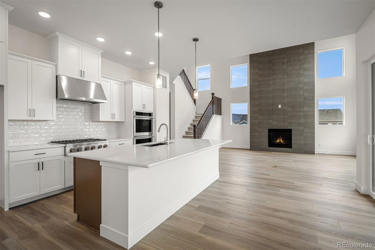 Fireplace, Interior, Kitchen, Pendant Lights, Recessed Lighting, Stainless Steel Appliances, Wood Texture Flooring