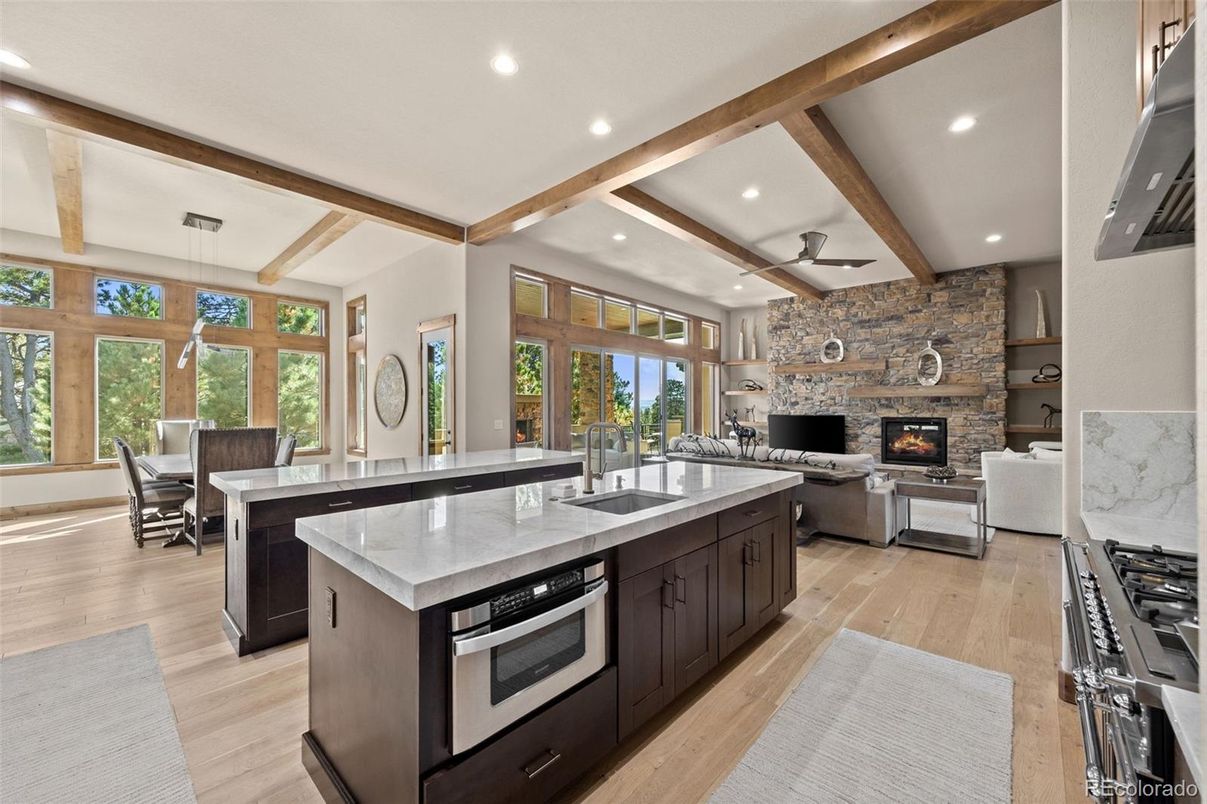 Dining room, Fireplace, Interior, Kitchen, Living room, Recessed Lighting, Stainless Steel Appliances, Stone Walls, Wooden Beams, Wood Texture Flooring