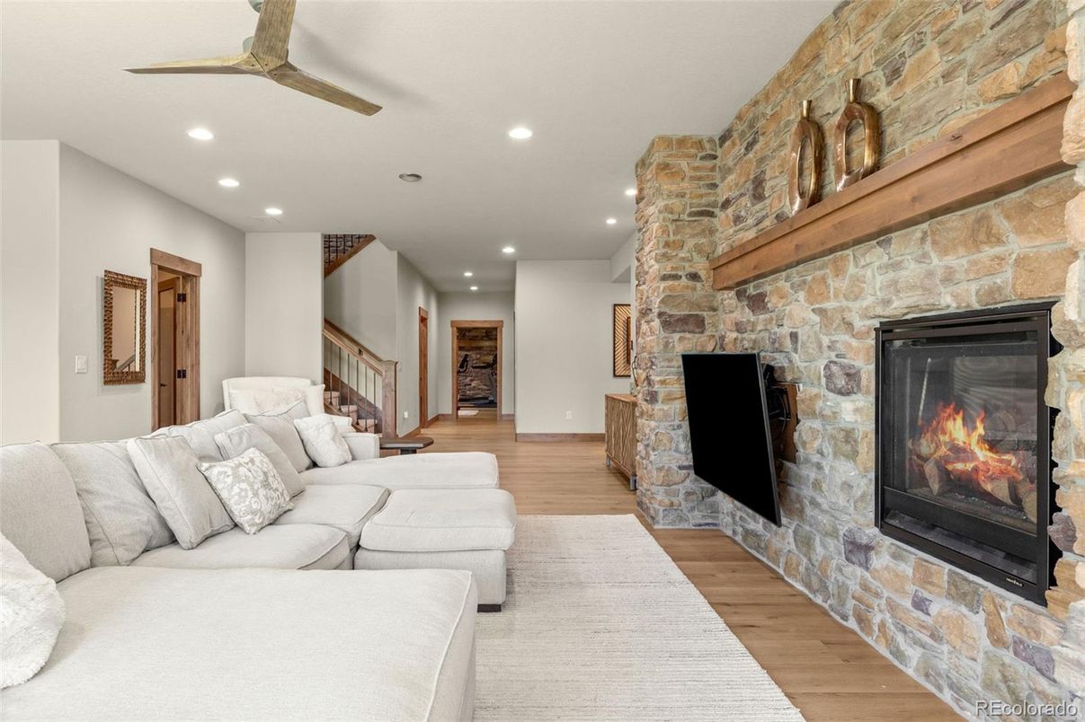 Fireplace, Interior, Living room, Recessed Lighting, Stone Walls, Wood Texture Flooring