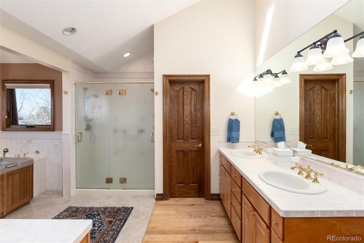 Bathroom, Dual Sink Vanities, Glass Shower, Interior, Recessed Lighting, Tile Countertops, Wood Texture Flooring