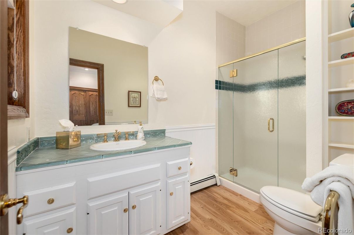 Bathroom, Glass Shower, Interior, Recessed Lighting, Tile Countertops, Wood Texture Flooring