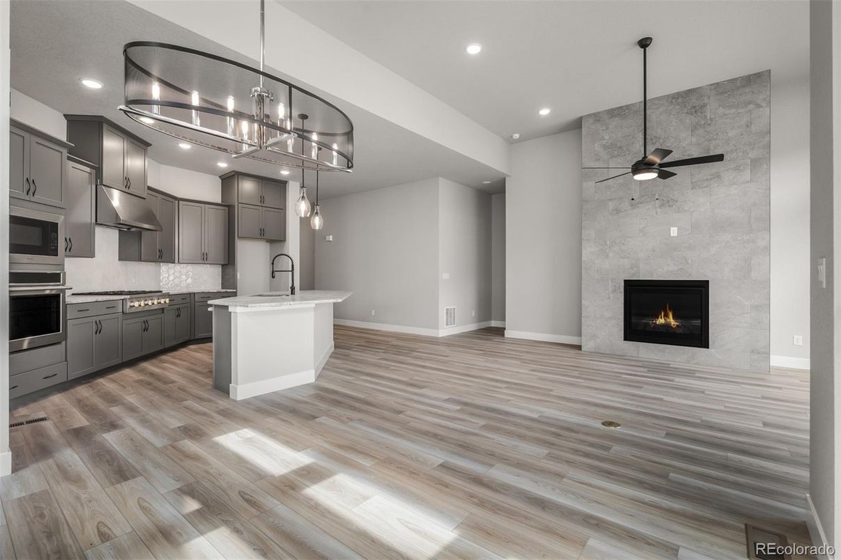 Fireplace, Interior, Kitchen, Pendant Lights, Recessed Lighting, Stainless Steel Appliances, Wood Texture Flooring