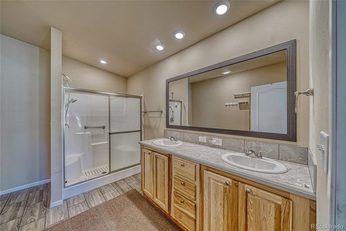 Bathroom, Dual Sink Vanities, Glass Shower, Interior, Recessed Lighting, Tile Countertops, Wood Texture Flooring