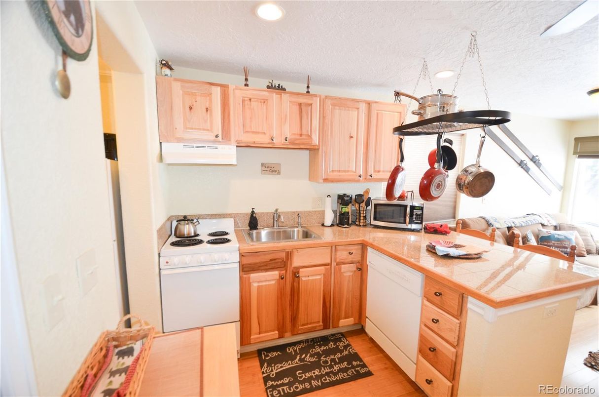 Interior, Kitchen, Recessed Lighting, Tile Countertops, Wood Texture Flooring