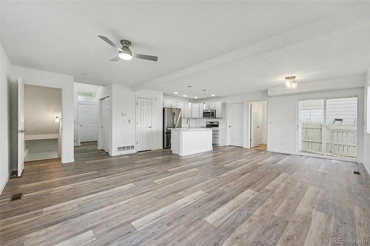 Empty room, Interior, Kitchen, Recessed Lighting, Stainless Steel Appliances, Wood Texture Flooring