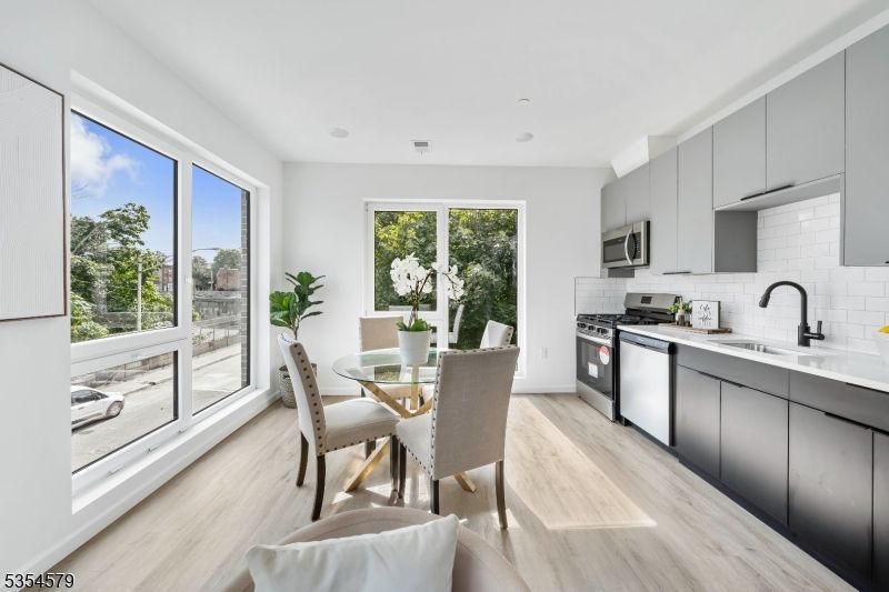 Dining room, Interior, Kitchen, Recessed Lighting, Stainless Steel Appliances, Wood Texture Flooring