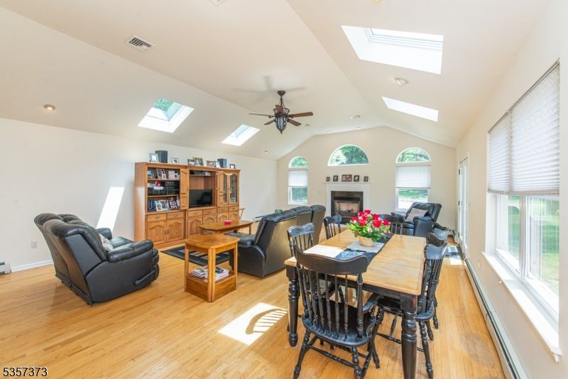 Dining room, Fireplace, Interior, Living room, Recessed Lighting, Wood Texture Flooring