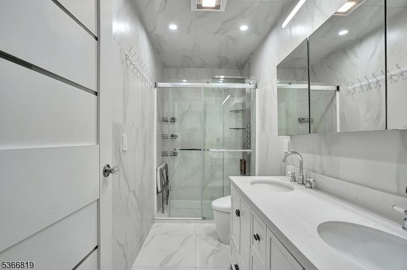 Bathroom, Dual Sink Vanities, Glass Shower, Interior, Marble, Marble Walls, Recessed Lighting