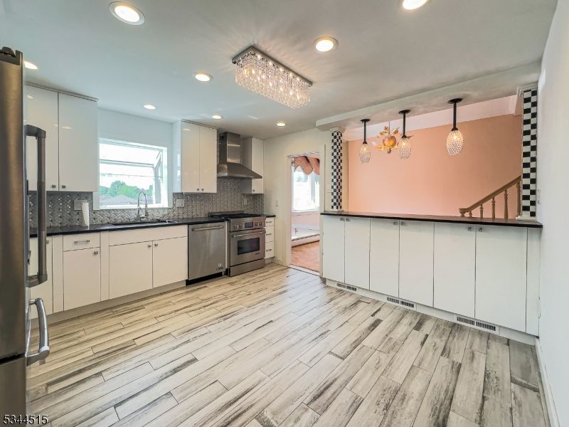 Chandelier, Interior, Kitchen, Pendant Lights, Recessed Lighting, Stainless Steel Appliances, Wood Texture Flooring