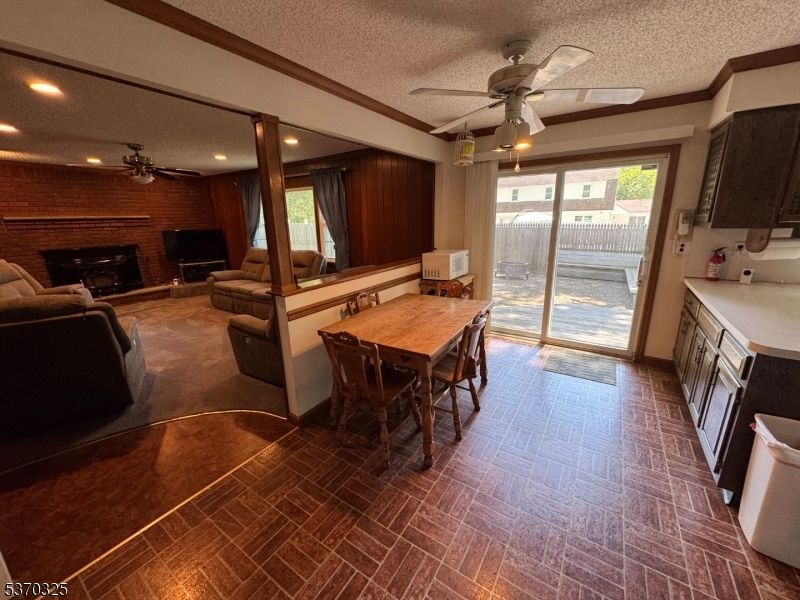 Dining room, Fireplace, Interior, Living room, Recessed Lighting, Stone Walls, Wooden Walls