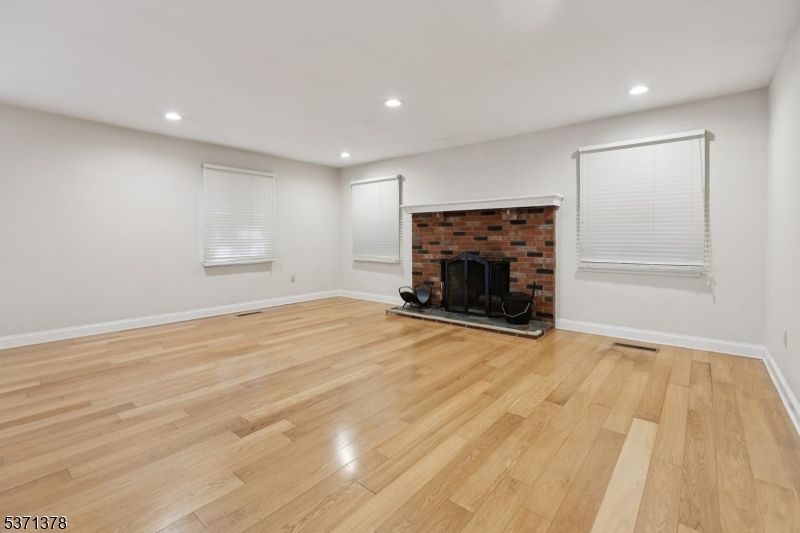 Empty room, Fireplace, Interior, Recessed Lighting, Stone Walls, Wood Texture Flooring