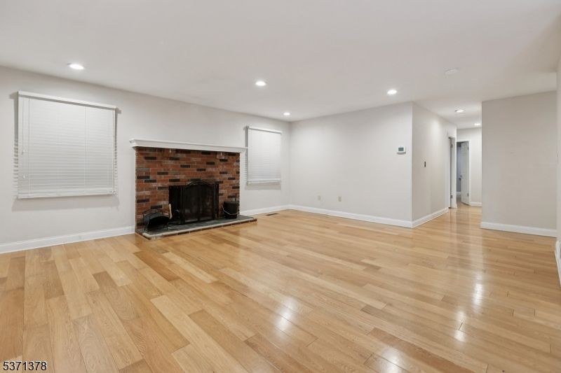 Empty room, Fireplace, Interior, Recessed Lighting, Stone Walls, Wood Texture Flooring