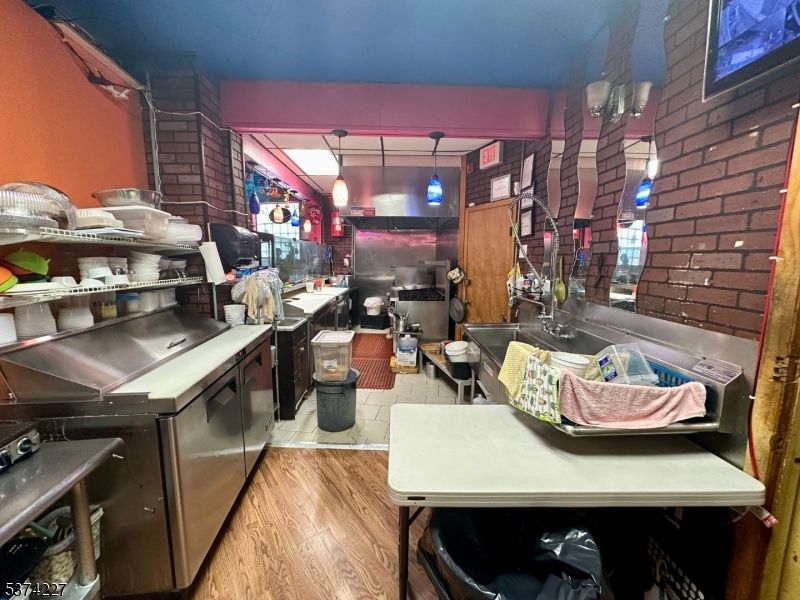 Interior, Kitchen, Pendant Lights, Stainless Steel Appliances, Stone Walls, Wood Texture Flooring