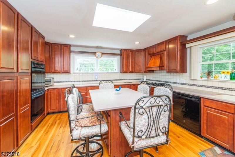 Interior, Kitchen, Recessed Lighting, Tile Countertops, Wood Texture Flooring