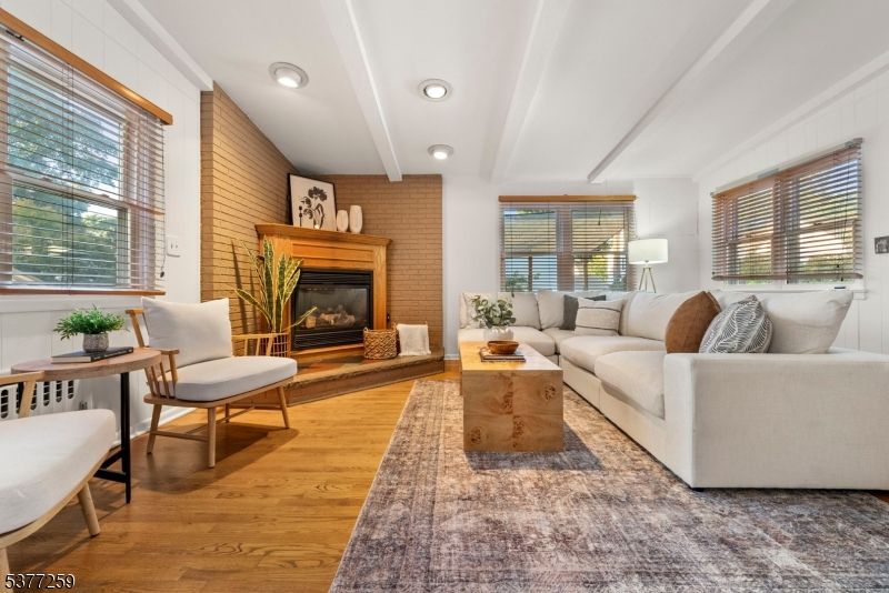 Fireplace, Interior, Living room, Recessed Lighting, Stone Walls, Wood Texture Flooring