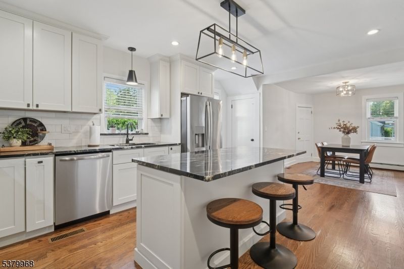 Chandelier, Dining room, Interior, Kitchen, Pendant Lights, Recessed Lighting, Stainless Steel Appliances, Wood Texture Flooring