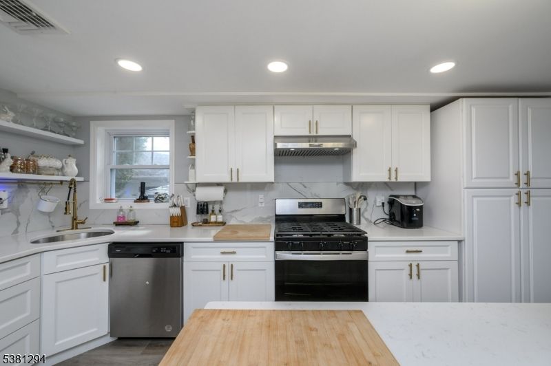 Interior, Kitchen, Marble Walls, Recessed Lighting, Stainless Steel Appliances, Wood Texture Flooring