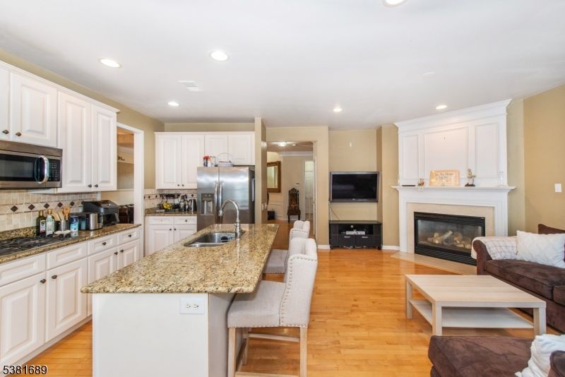 Fireplace, Interior, Kitchen, Living room, Recessed Lighting, Stainless Steel Appliances, Wood Texture Flooring