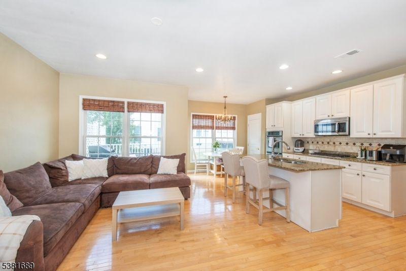 Chandelier, Dining room, Interior, Kitchen, Living room, Recessed Lighting, Stainless Steel Appliances, Wood Texture Flooring