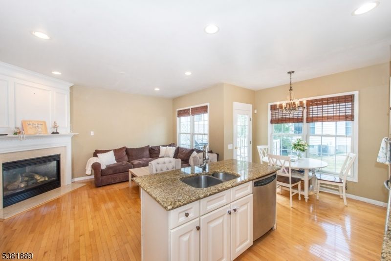 Chandelier, Dining room, Fireplace, Interior, Kitchen, Living room, Recessed Lighting, Wood Texture Flooring