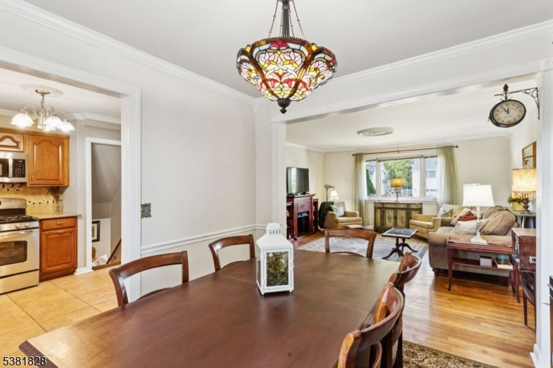 Chandelier, Dining room, Interior, Kitchen, Living room, Pendant Lights, Stainless Steel Appliances, Wood Texture Flooring