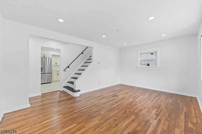 Empty room, Interior, Kitchen, Recessed Lighting, Stainless Steel Appliances, Wood Texture Flooring