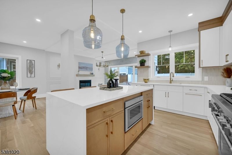 Dining room, Fireplace, Interior, Kitchen, Pendant Lights, Recessed Lighting, Stainless Steel Appliances, Wood Texture Flooring