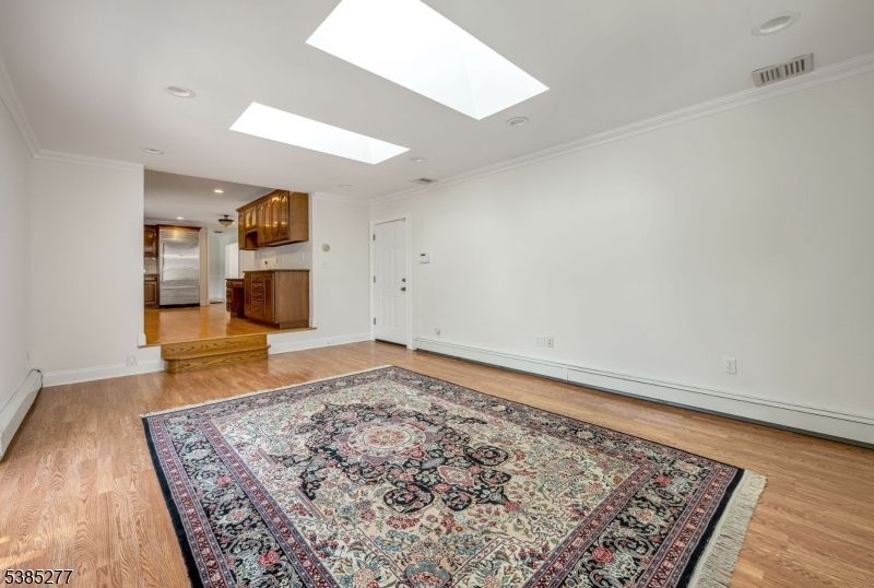 Empty room, Interior, Kitchen, Recessed Lighting, Stainless Steel Appliances, Wood Texture Flooring