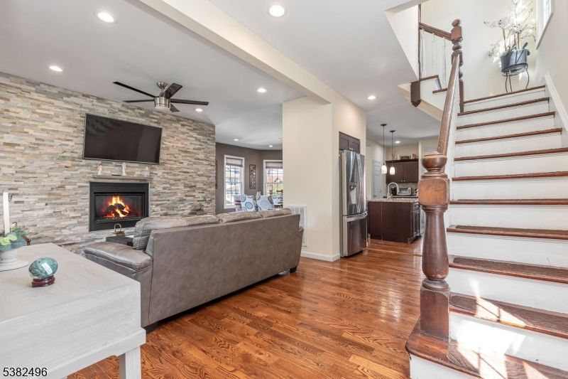 Fireplace, Interior, Kitchen, Living room, Pendant Lights, Recessed Lighting, Stainless Steel Appliances, Stone Walls, Wood Texture Flooring