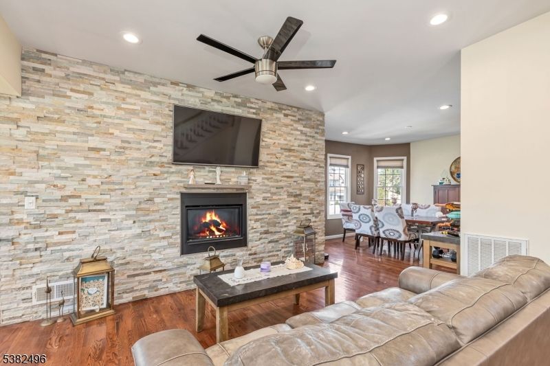 Dining room, Fireplace, Interior, Living room, Recessed Lighting, Stone Walls, Wood Texture Flooring