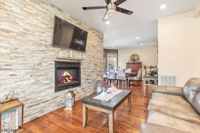 Dining room, Fireplace, Interior, Living room, Recessed Lighting, Stone Walls, Wood Texture Flooring