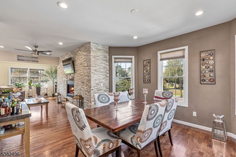 Dining room, Fireplace, Interior, Living room, Recessed Lighting, Stone Walls, Wood Texture Flooring