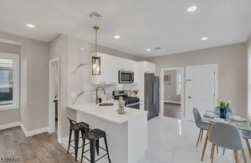 Dining room, Interior, Kitchen, Pendant Lights, Recessed Lighting, Stainless Steel Appliances, Wood Texture Flooring