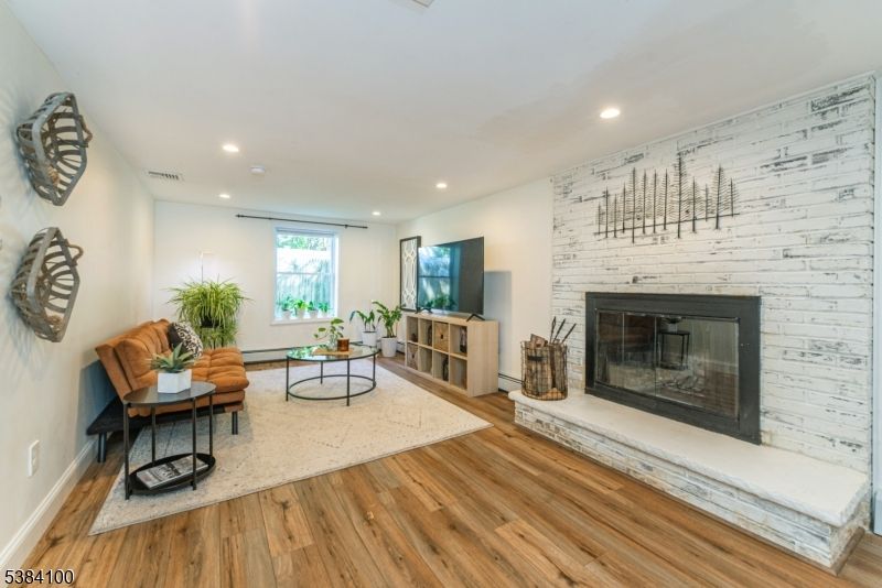 Fireplace, Interior, Living room, Recessed Lighting, Stone Walls, Wood Texture Flooring