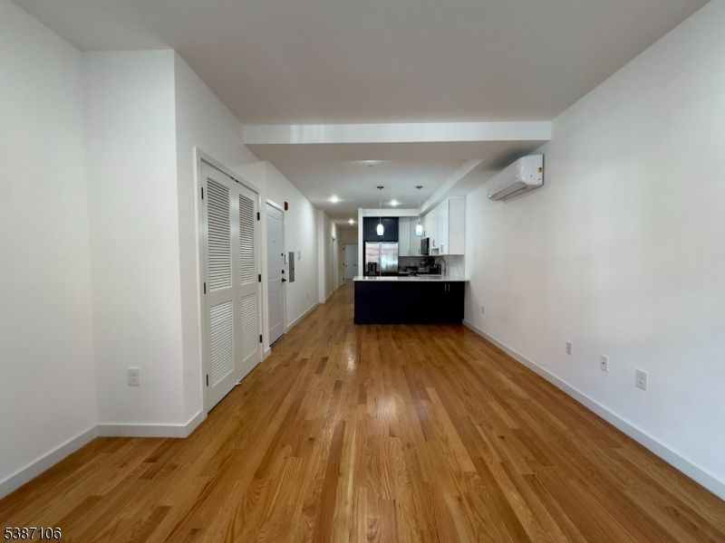 Empty room, Interior, Kitchen, Pendant Lights, Recessed Lighting, Stainless Steel Appliances, Wood Texture Flooring