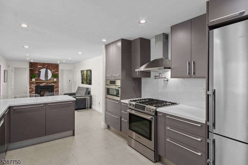 Fireplace, Interior, Kitchen, Recessed Lighting, Stainless Steel Appliances, Stone Walls