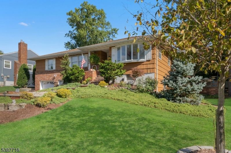 Attached, Backyard, Exterior, Facade, Brick Facade, Raised Ranch