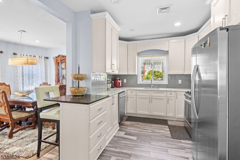 Dining room, Interior, Kitchen, Pendant Lights, Recessed Lighting, Stainless Steel Appliances, Wood Texture Flooring