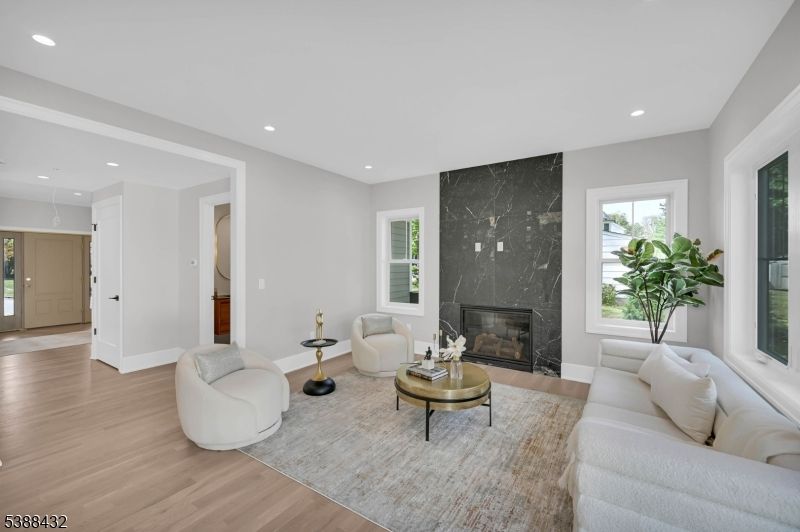 Fireplace, Interior, Living room, Marble Walls, Recessed Lighting, Wood Texture Flooring