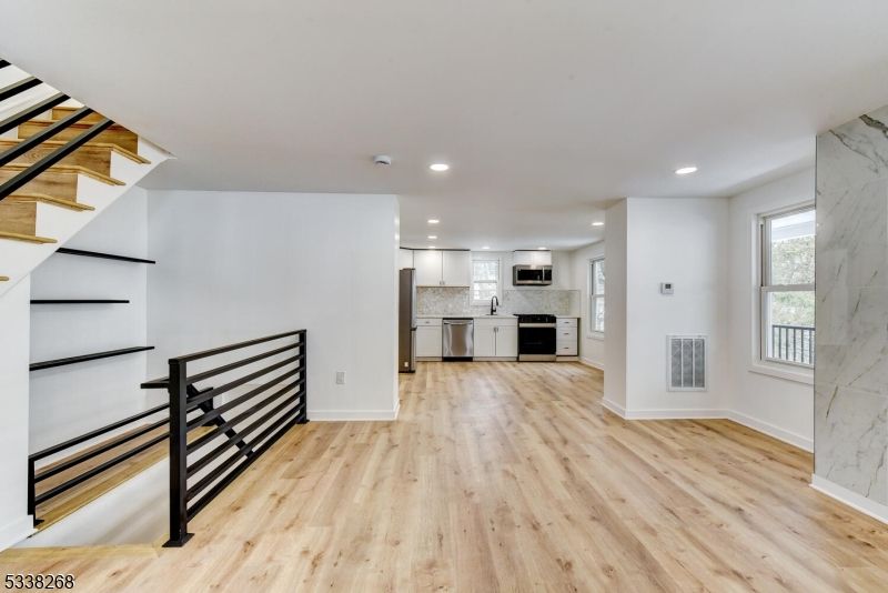 Empty room, Interior, Kitchen, Recessed Lighting, Stainless Steel Appliances, Wood Texture Flooring