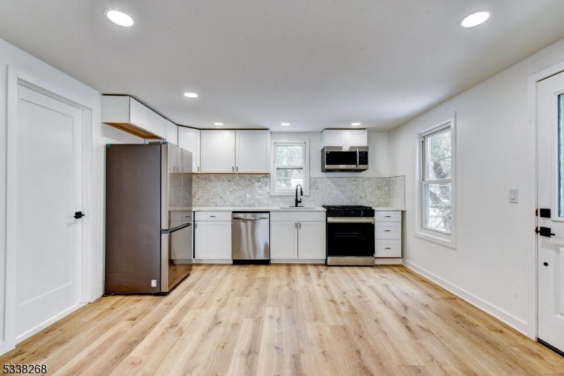 Interior, Kitchen, Marble Walls, Recessed Lighting, Stainless Steel Appliances, Wood Texture Flooring