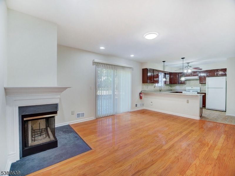 Empty room, Fireplace, Interior, Kitchen, Pendant Lights, Recessed Lighting, Wood Texture Flooring