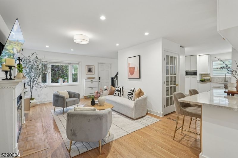 Dining room, Fireplace, Interior, Living room, Recessed Lighting, Wood Texture Flooring