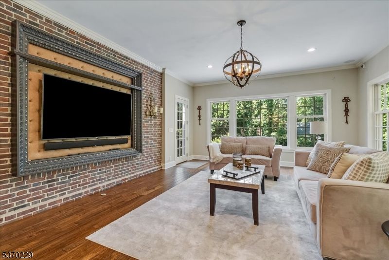 Chandelier, Fireplace, Interior, Living room, Recessed Lighting, Stone Walls, Wood Texture Flooring