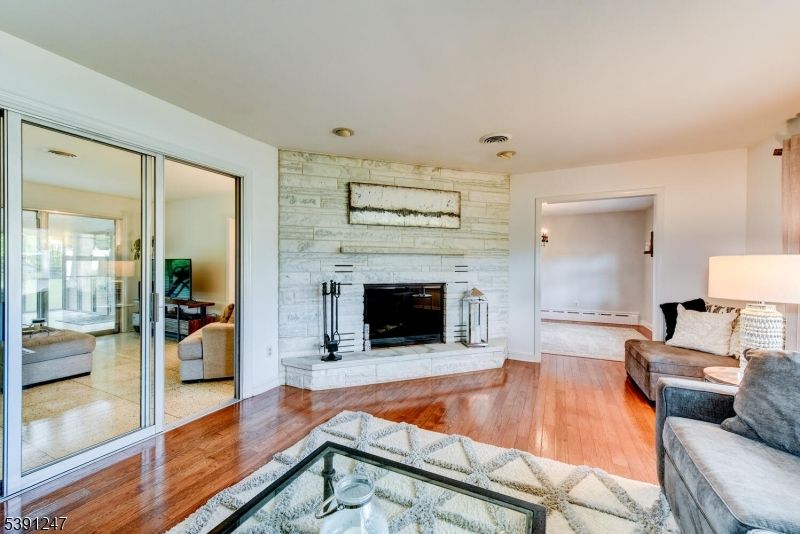 Fireplace, Interior, Living room, Recessed Lighting, Stone Walls, Wood Texture Flooring