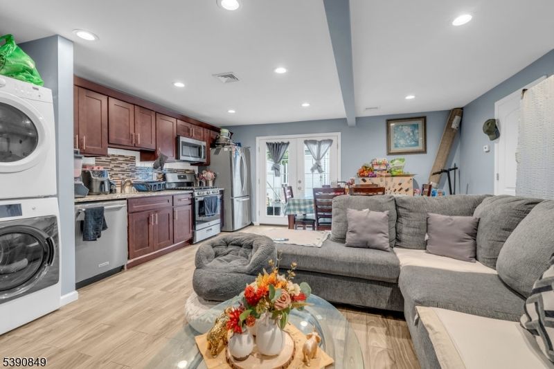 Dining room, Interior, Kitchen, Living room, Recessed Lighting, Stainless Steel Appliances, Washer, Wood Texture Flooring