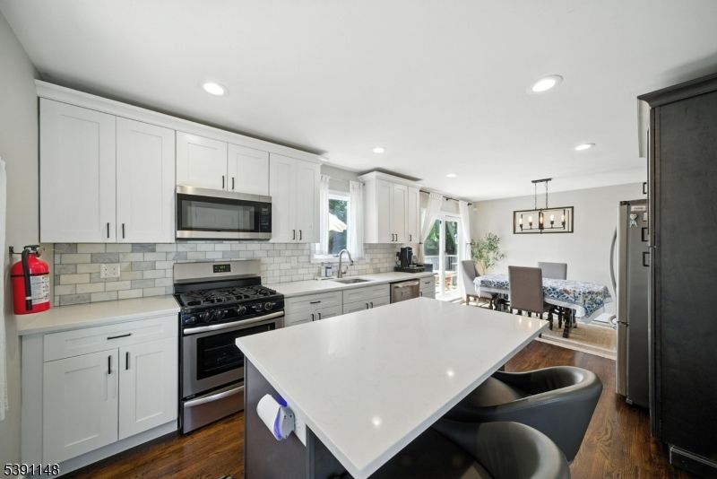 Dining room, Interior, Kitchen, Pendant Lights, Recessed Lighting, Stainless Steel Appliances, Wood Texture Flooring
