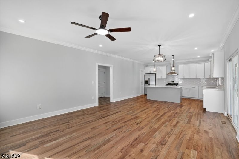Empty room, Interior, Kitchen, Pendant Lights, Recessed Lighting, Stainless Steel Appliances, Wood Texture Flooring